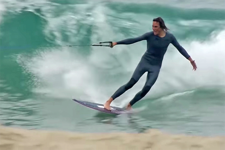 Skimboarding: towed into by wave by a lawn mower engine